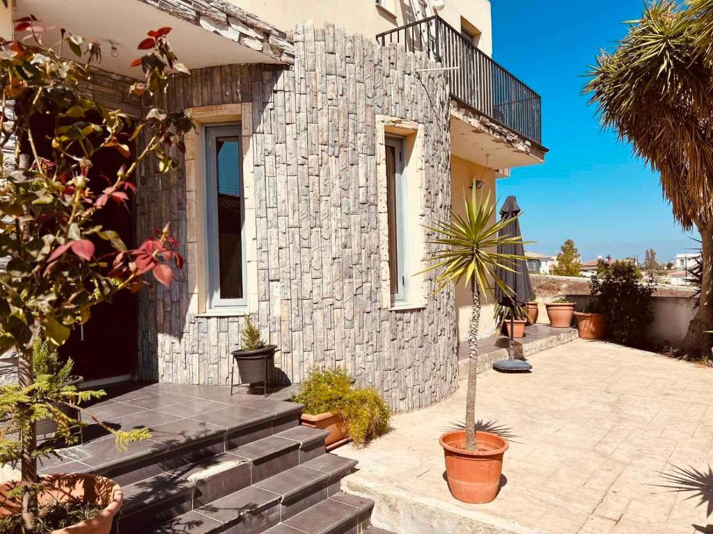 a stone house with stairs and plants in front of it at Impeccable 3-Bed Villa in Nicosia in Yukarı Lakatamya