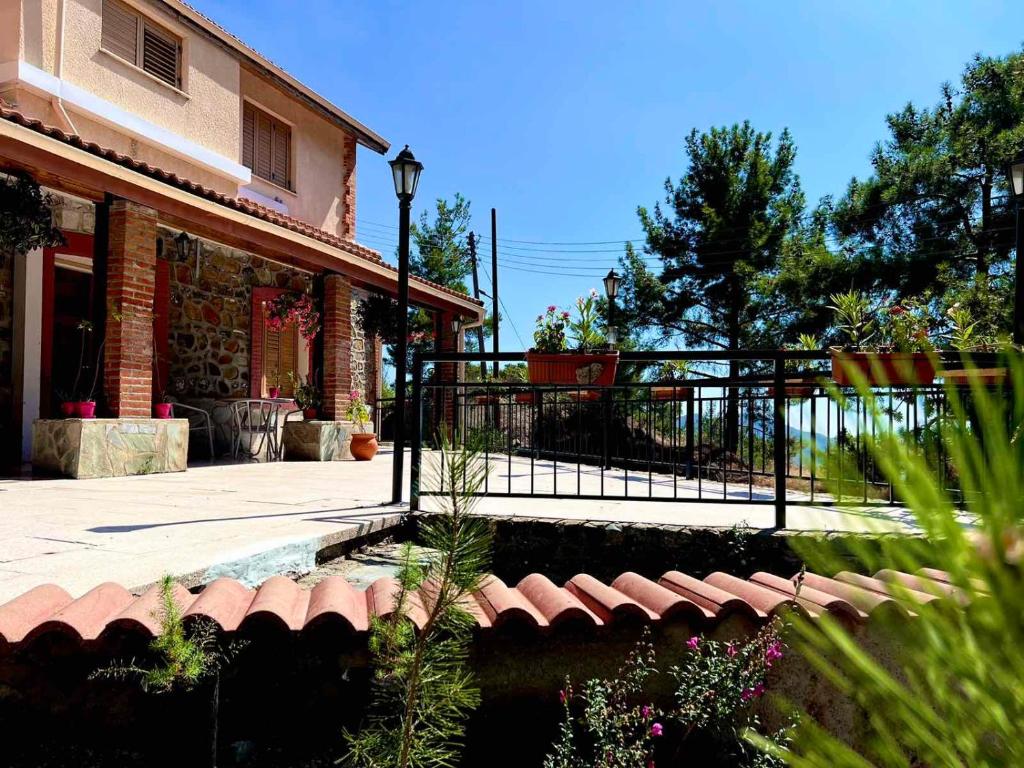 a house with a fence and a patio at VILLA AURA by AgroHolidays in Platres