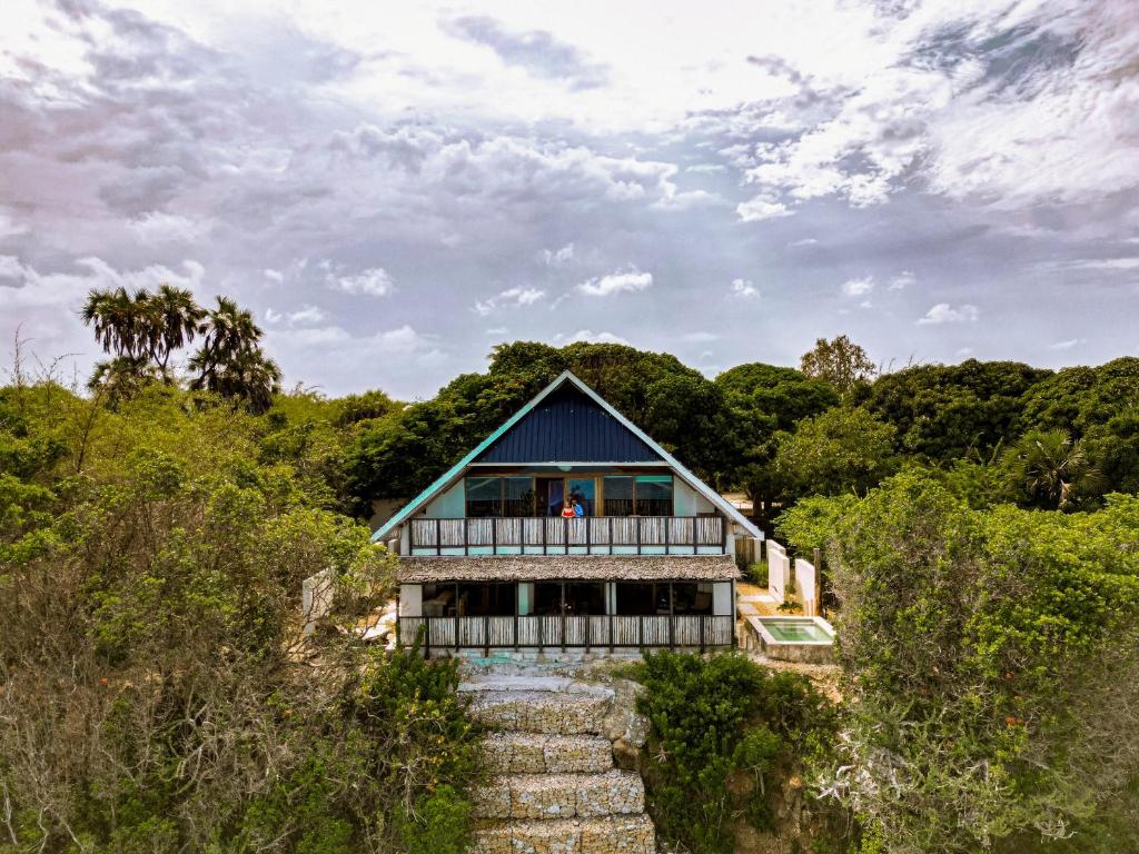 a house with a blue roof on a hill at The Overhang in Dar es Salaam