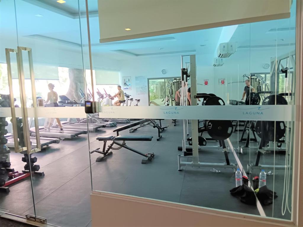 a gym with glass walls and people in the gym at Laguna Beach Resort 3 Maldives in Jomtien Beach