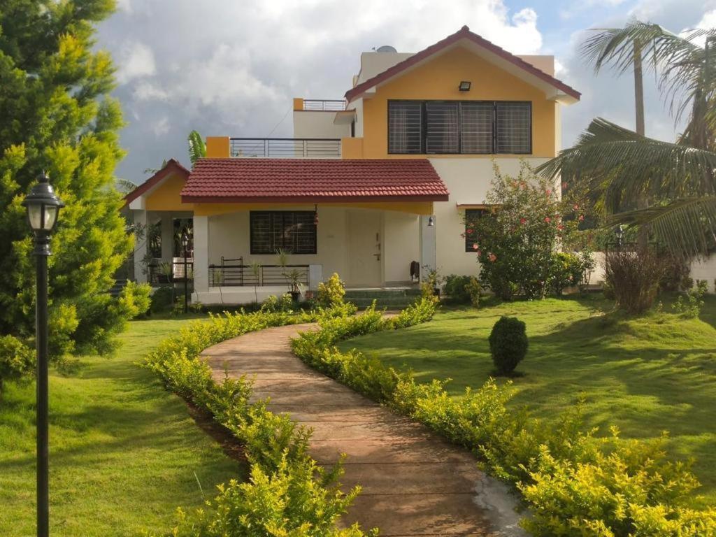 a house with a pathway in front of it at JACK & JILL COTTAGE in Yelagiri