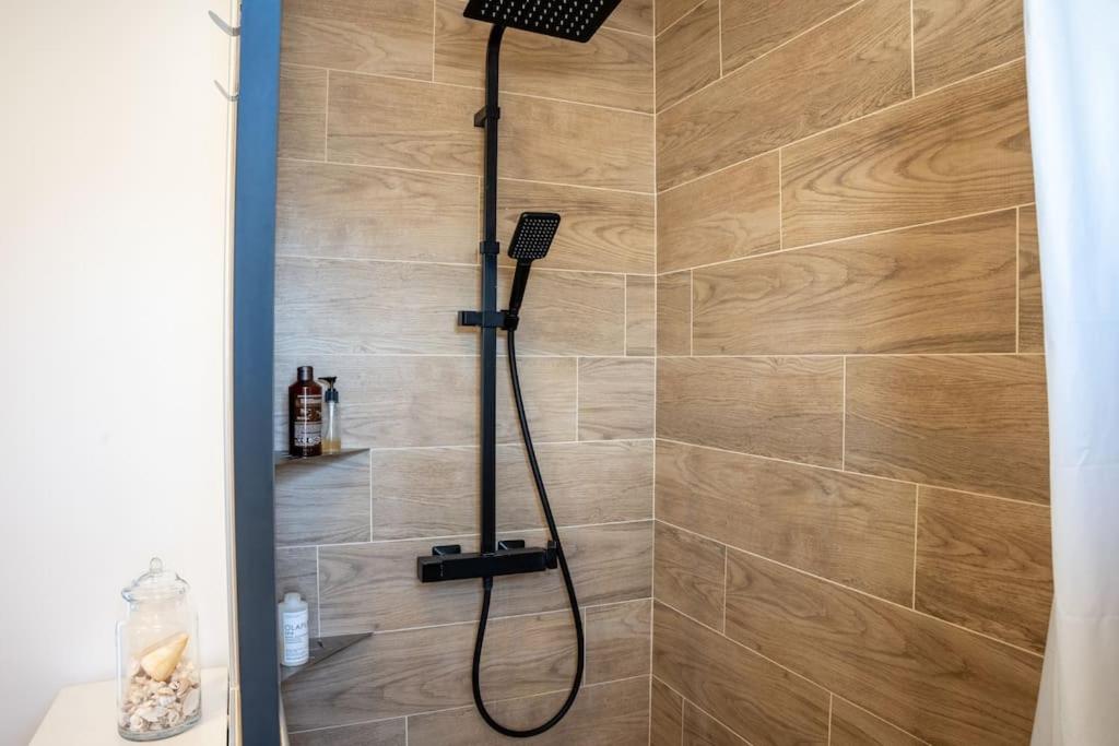 a shower with a shower head in a bathroom at Les Hirondelles By Nid&#39;Ouest in Quimper