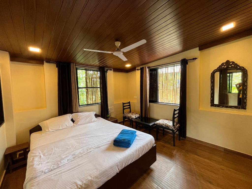 a bedroom with a bed and a ceiling fan at Rocky in Mumbai