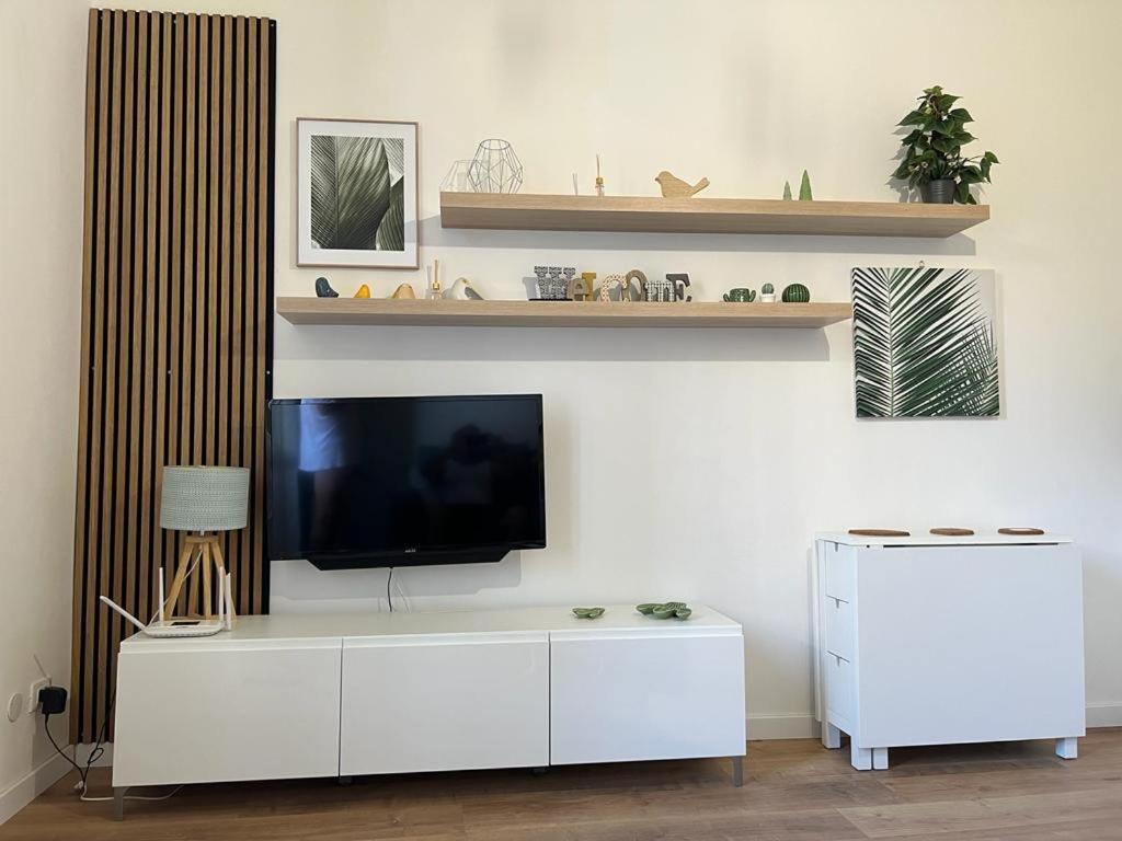 een woonkamer met een televisie op een witte kast bij Pandolf in Bologna