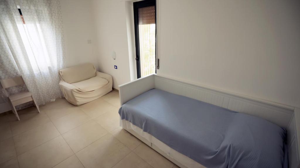 Postel nebo postele na pokoji v ubytování B&B L'Oasi