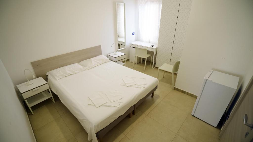Postel nebo postele na pokoji v ubytování B&B L'Oasi