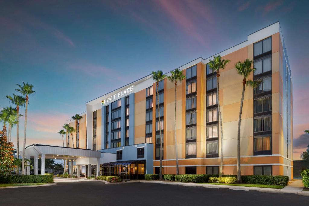 a rendering of a hotel with palm trees at Hyatt Place across from Universal Orlando Resort in Orlando