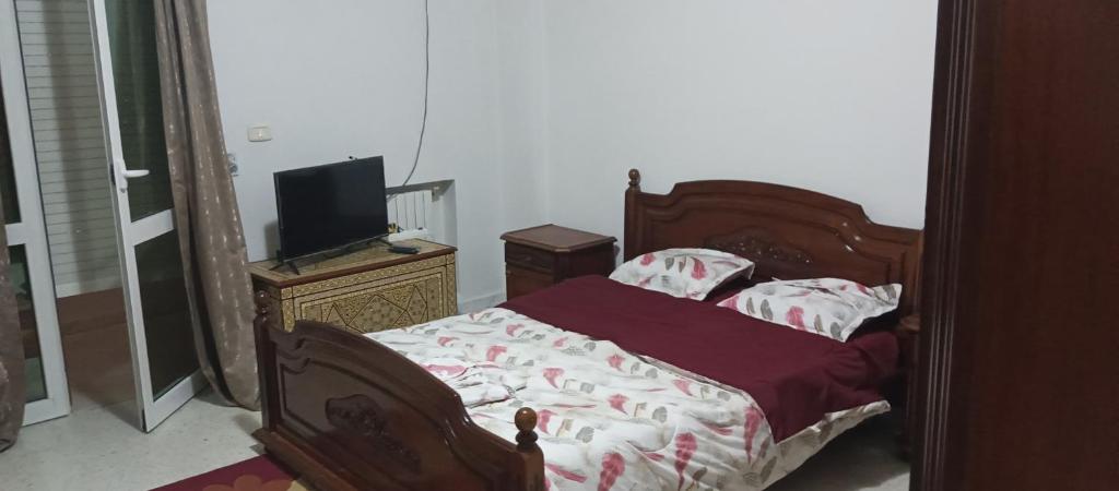 a bedroom with a bed and a tv in it at Well furnished appartment , Sahloul sousse in Sousse