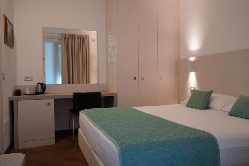 Postel nebo postele na pokoji v ubytování Hotel Ponti