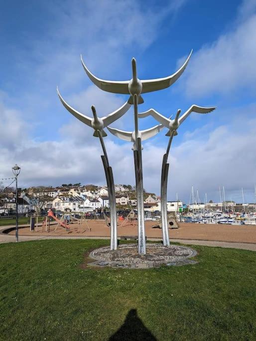 a large statue in a park next to a beach at Seafront Sanctuary Ballycastle in Ballycastle