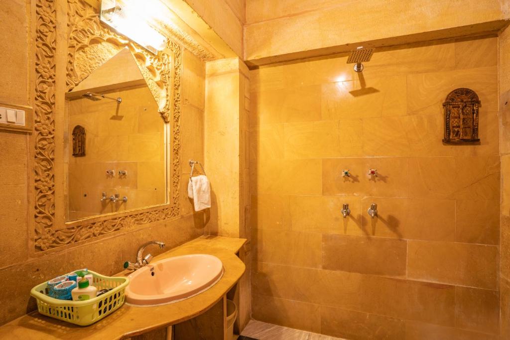 a bathroom with a sink and a shower at Hotel Garh Jaisal Haveli in Jaisalmer