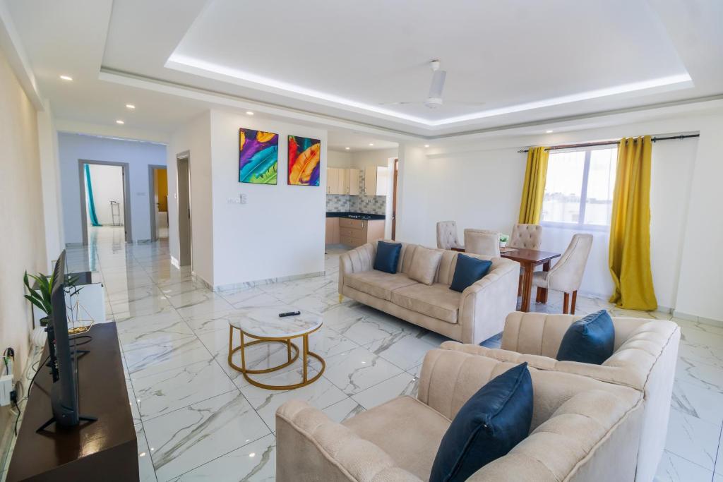 a living room with two couches and a table at Luxury 3br Ensuite Apt in Prestigious Nyali in Mombasa