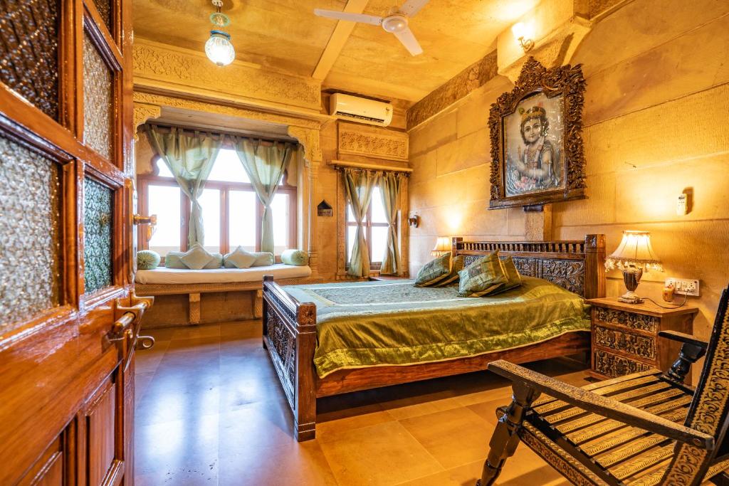 a bedroom with a large bed and a window at Hotel Garh Jaisal Haveli in Jaisalmer