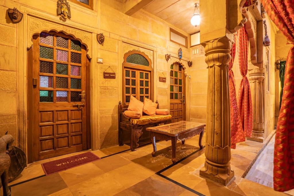 a living room with a couch and a table at Hotel Garh Jaisal Haveli in Jaisalmer