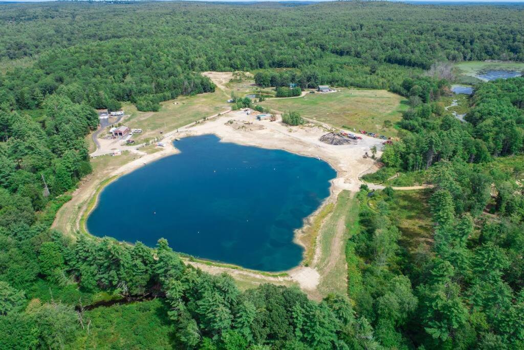 an aerial view of a lake in the woods at Studio Apt - Nottingham NH in Nottingham