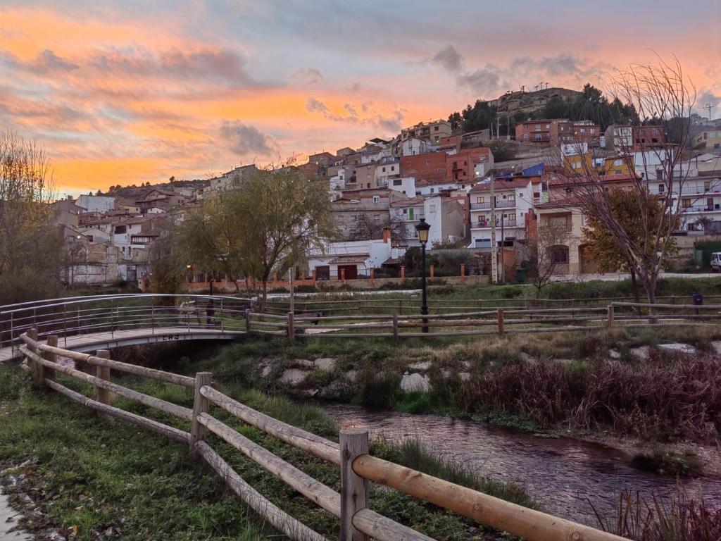 a bridge over a river with a town in the background at EL RECOVECO DE MIRA in Mira