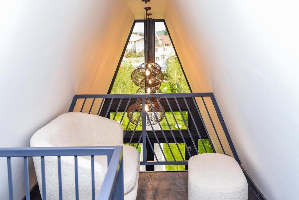 a room with two chairs and a window at Anna Chalet in Breaza de Sus