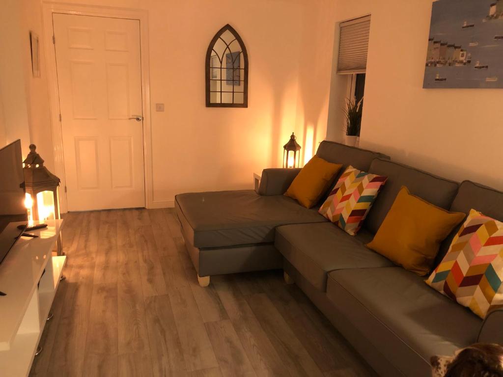 a living room with a couch and a table at Saint’s Retreat Whitby in Whitby