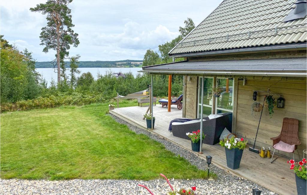 a house with a deck with a view of the water at Stunning Home In Grdinge With Kitchen 