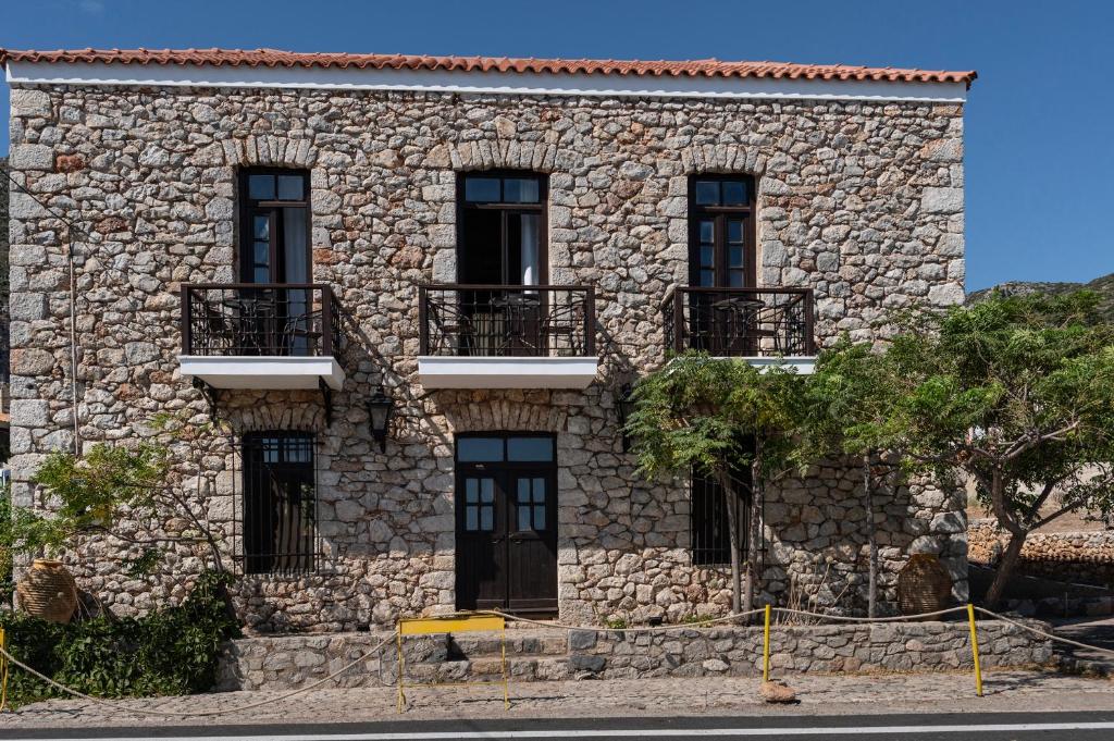 um edifício de pedra com janelas e varandas em Belessi's Mansion em Yéfira