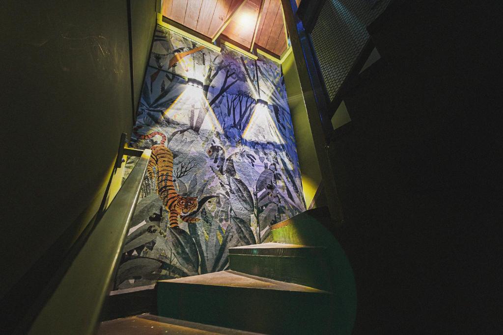 a staircase with a painting of a tiger on a wall at hotel velero cavancha in Iquique