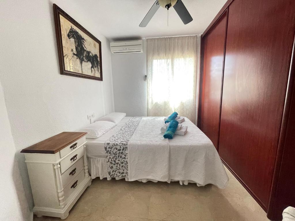 a bedroom with a bed with a teddy bear on it at Apartamento Las Brisas in Mijas