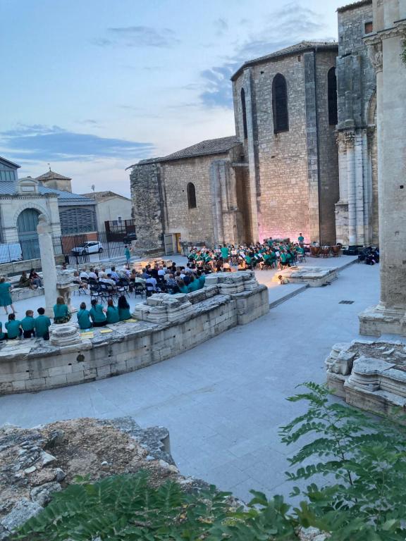 a group of people sitting in front of a building at Maison au cœur de la Ville. in Saint-Gilles