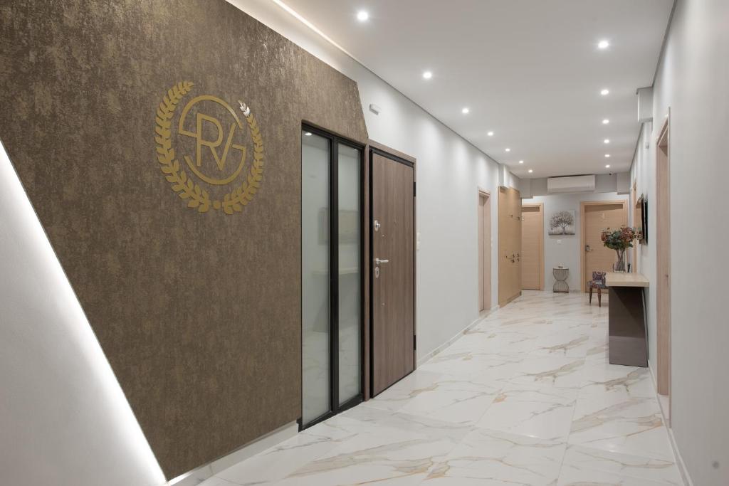 a corridor of a building with a logo on the wall at Rob Venture Suites at the central of ATHENS city in Athens