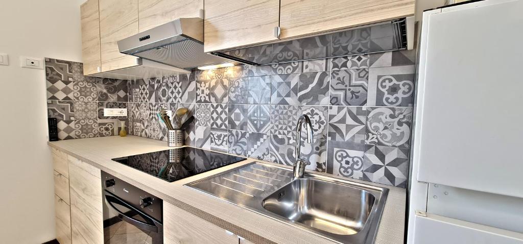 a small kitchen with a sink and a stove at La Ca' Maggiore Affittaly Apartments in Bologna