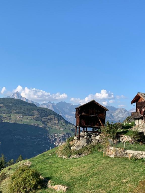 a group of huts on a hill with a lake at Gaby in Grächen