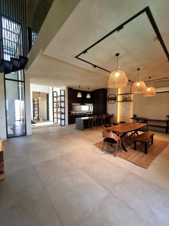 a large living room with a table and chairs at The Gate in Sur