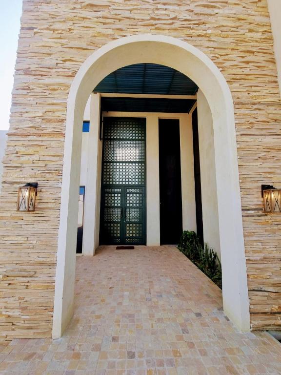 an entrance to a building with a black door at The Gate in Sur