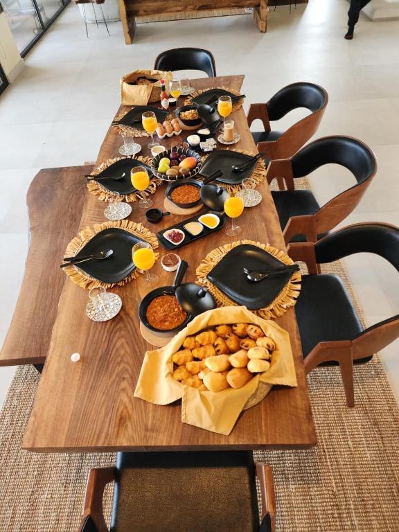 a long wooden table with a bunch of food on it at The Gate in Sur
