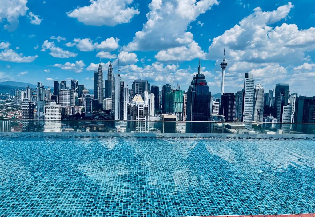 uma piscina com vista para o horizonte da cidade em Regalia suites 424 em Kuala Lumpur