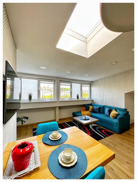 a living room with a blue couch and a table at Apartaments in the city centre in Kaunas