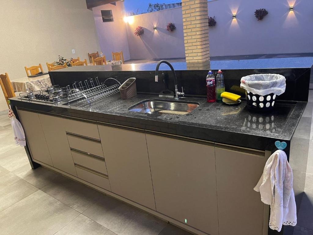 a kitchen with a sink and a counter top at Império D in Tanabi