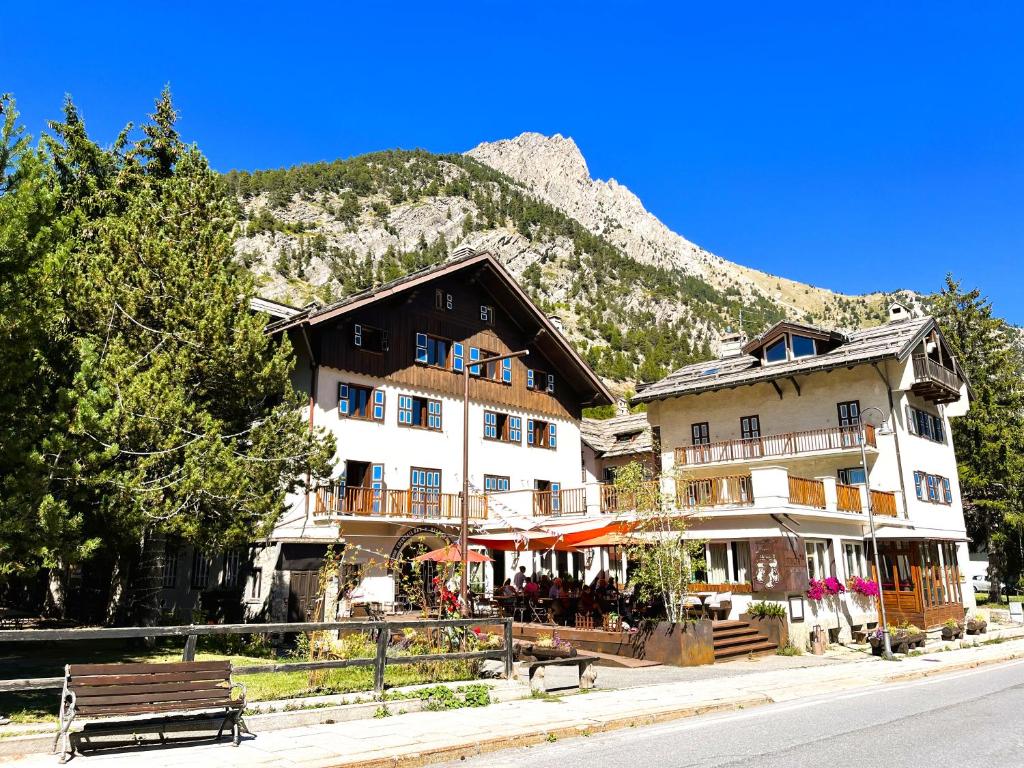 a group of buildings in front of a mountain at Aparthotel Claviere in Claviere