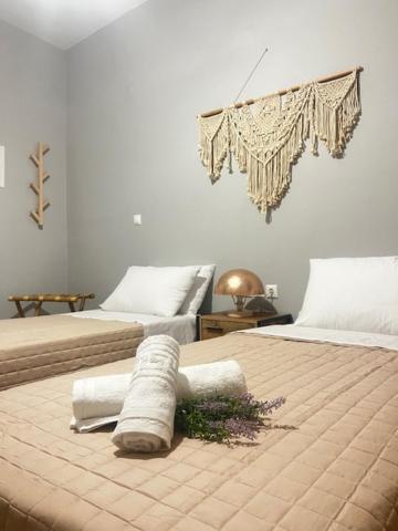 a bedroom with two beds with towels on them at LA COSTA DI SAN GIORGIO in Agios Georgios