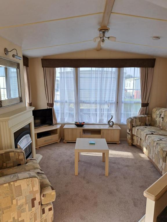 a living room with a couch and a table at Seaview in Skegness