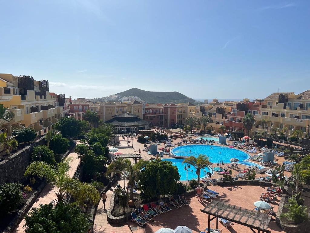 a view of a resort with a swimming pool at Sunny Apartment & Heated pool in Los Cristianos