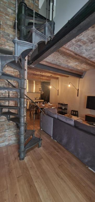 escalera de caracol metálica en una habitación con sofá en Maison village Camargue 4/6 pers, en Aimargues