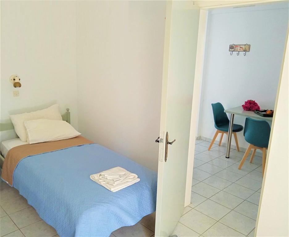 a bedroom with a bed and a table and a table and chairs at Valentino in Kalymnos