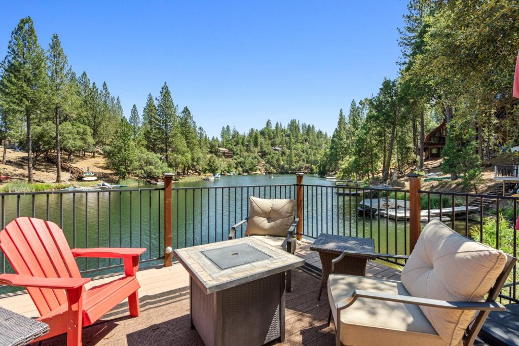 a deck with chairs and a table with a view of a lake at Water's Edge - Gorgeous Water Views! home in Groveland