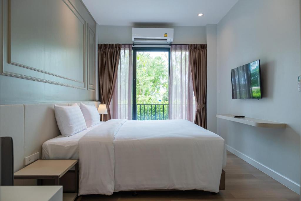 Postel nebo postele na pokoji v ubytování Wellington Hotel Prachuapkhirikhan