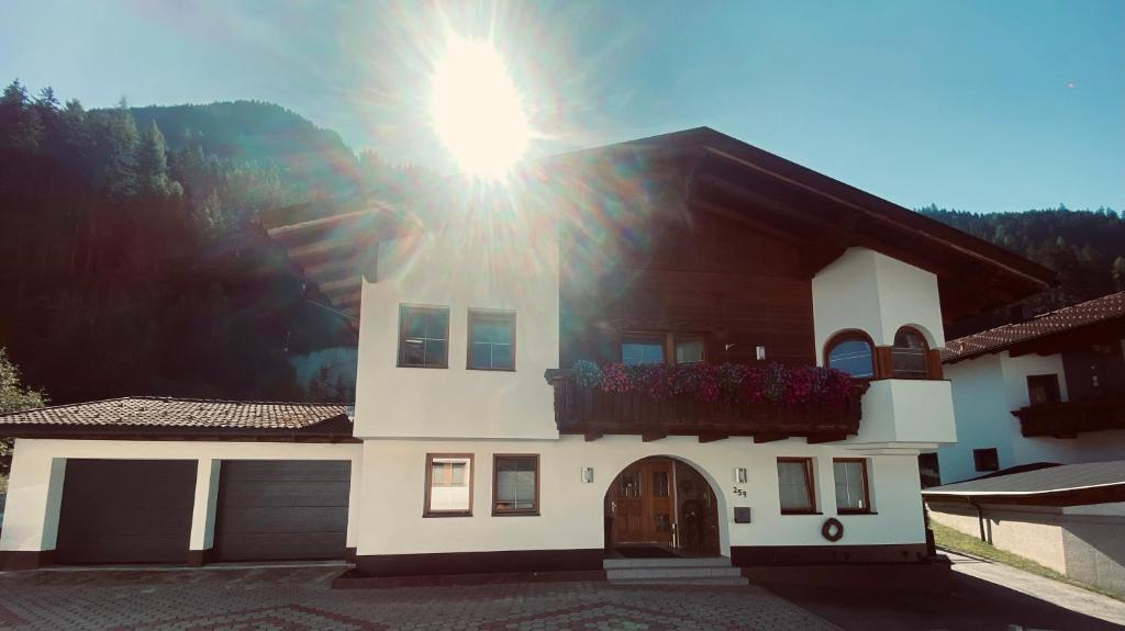 a house with the sun shining on top of it at Haus Lydia in See
