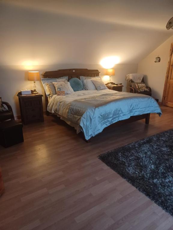 a bedroom with a bed with blue sheets and pillows at Country Haven eircode H54 AK31 in Galway