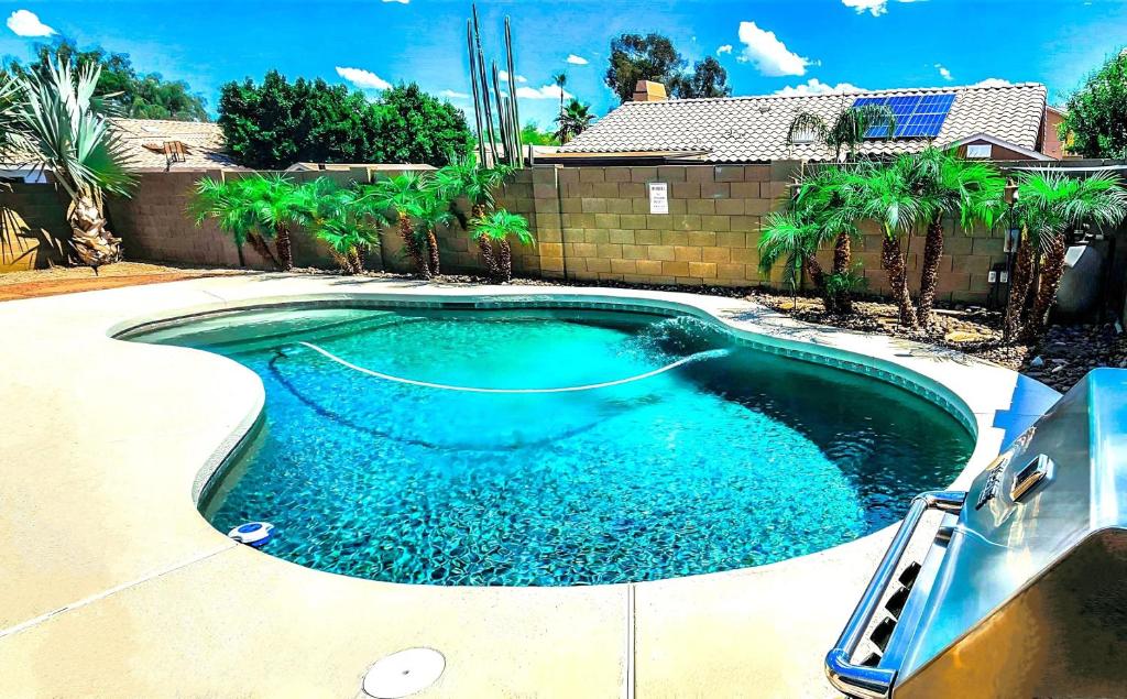 a swimming pool with blue water in a yard at North Phoenix At Your Fingertips in Phoenix