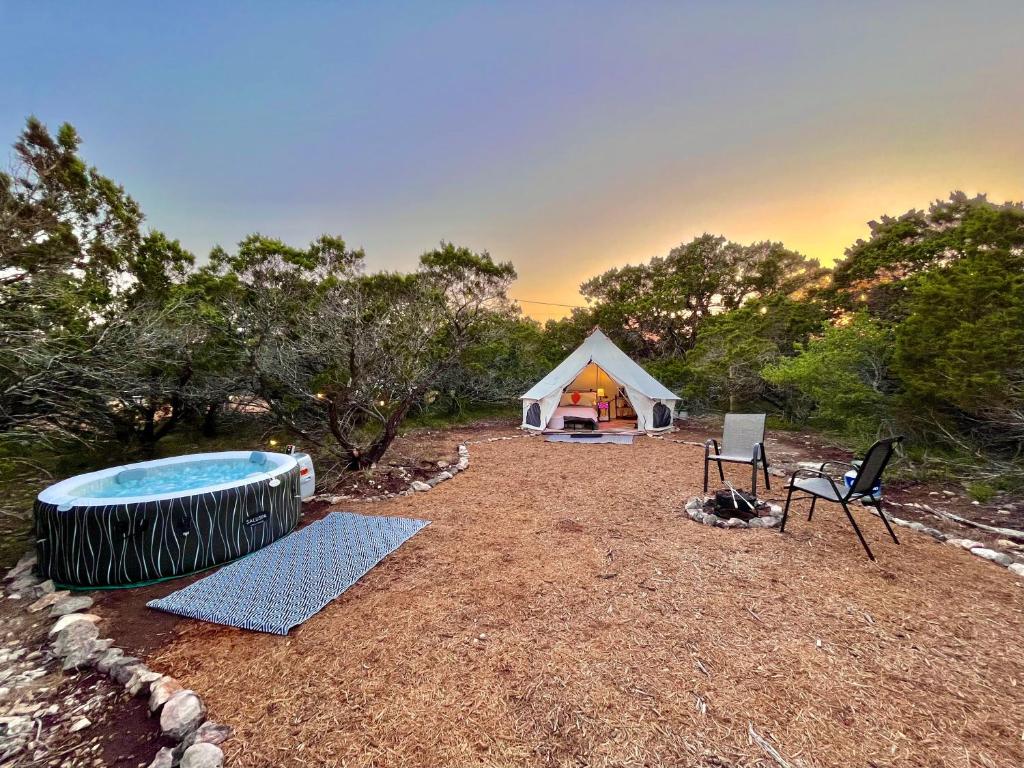 Tienda y bañera de hidromasaje en un campo en The Juniper Ranch and Retreat en Canyon Lake