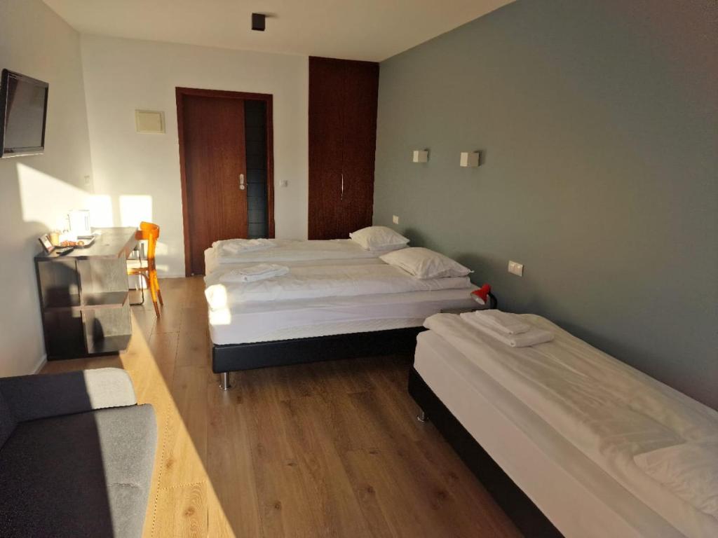 a room with two beds and a television in it at Studio 22 in Reyðarfjörður