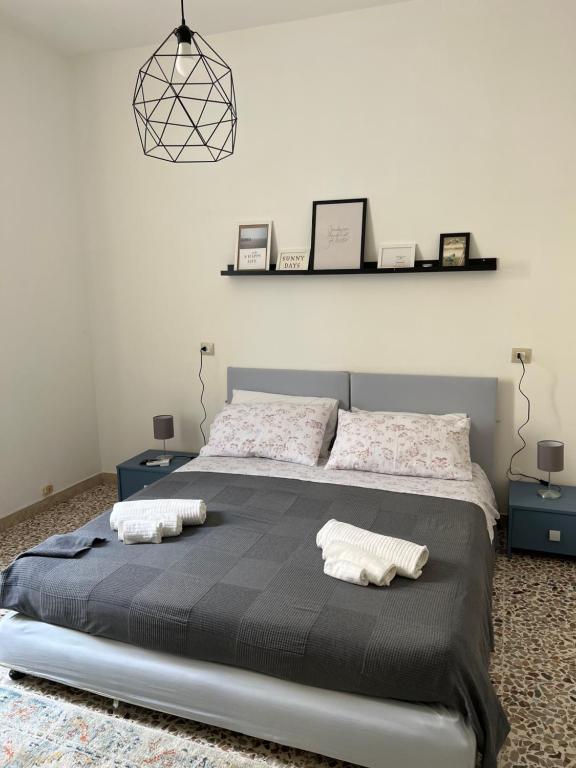 a bedroom with a large bed with two pillows on it at 10 MAGGIO APARTMENTS in Augusta